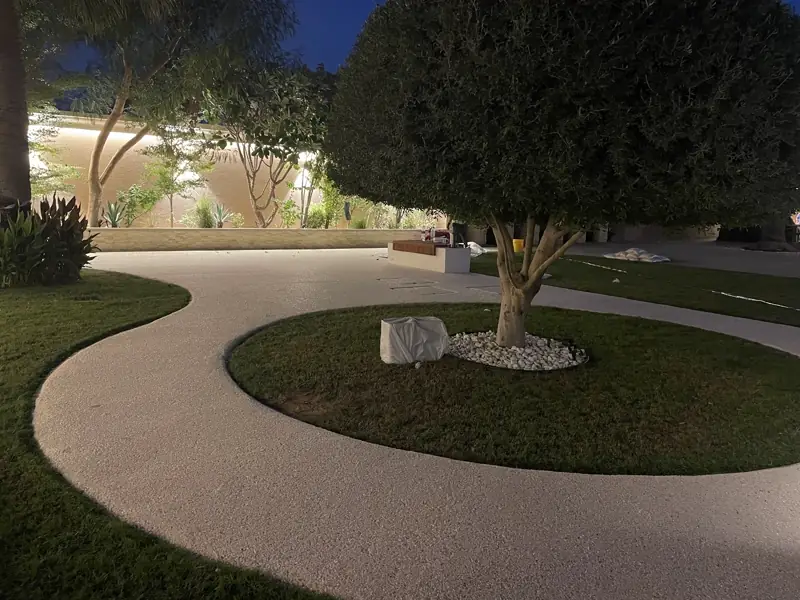 S-curve resin bound pathway through a garden at night, Abu Dhabi