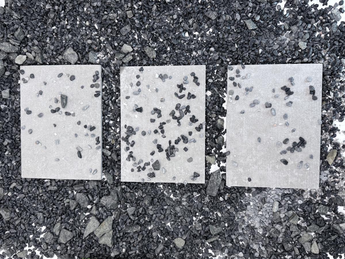 Loose pebbles scattered across stepping stones in a garden walkway