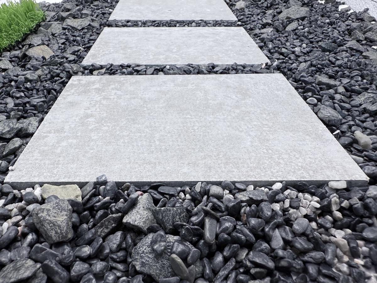 Finished garden walkway with stepping stones surrounded by neatly arranged pebbles